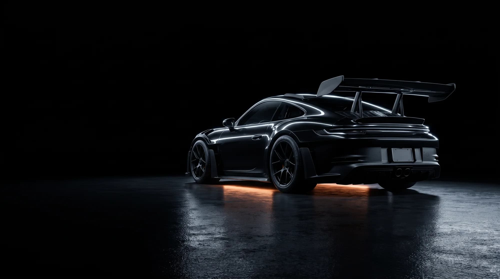 Black sports car with warm rim lighting in a dark studio
